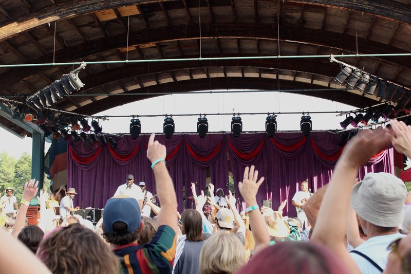 Festival audience with hands raised during the set